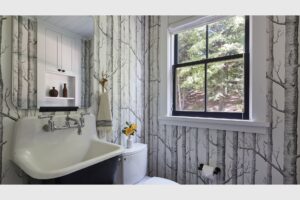 A cabin bathroom with birch wallpaper